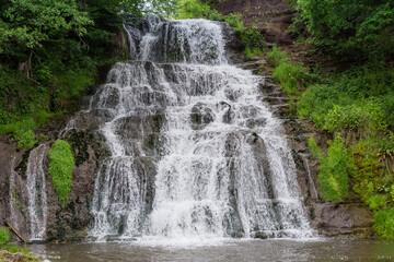 Upper cascade of Dzhurynskyi waterfall in spring overcast day, Ukraine