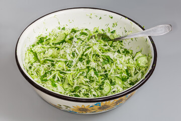 Green salad of sliced fresh vegetables in big kitchen bowl