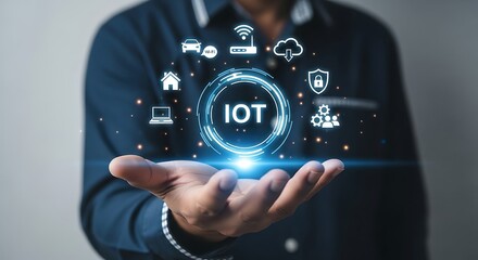 Person with open palm holding glowing IOT technology circle with cloud laptop and network icons in a modern blue visual