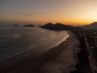 Incredible orange sunset on a beach in the middle of the forest