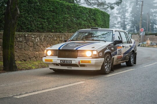 speeding through a misty road with headlights illuminating the fog.