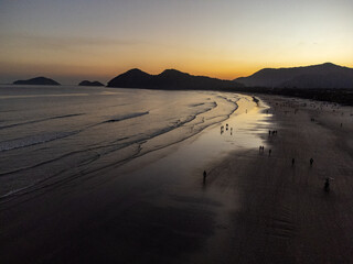 Incredible orange sunset on a beach in the middle of the forest