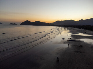 Incredible orange sunset on a beach in the middle of the forest