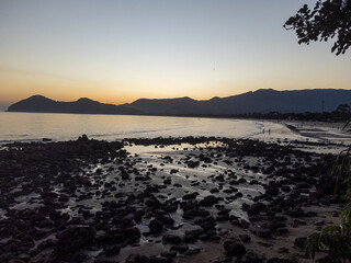 Incredible orange sunset on a beach in the middle of the forest