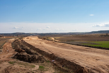 Massive earthworks for a new highway construction in the countryside.