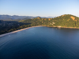 Sunset light on beach amidst mountains