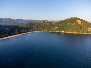 Sunset light on beach amidst mountains