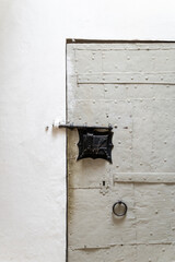 Medieval metal door with fittings and masonry inside a cathedral