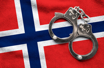 Flag of Norway and police handcuffs. Crime and offenses in country Concept
