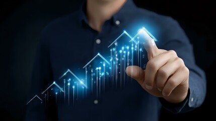 Professional in navy shirt points to glowing blue financial chart showing upward trend with digital arrows and data visualization elements on dark background.