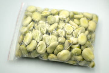 Broad beans in a plastic bag.
