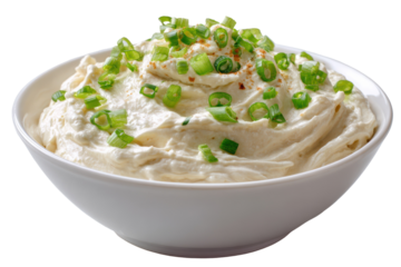 Creamy dip with green onions in white bowl delicious appetizer isolated on a transparent background