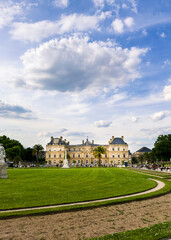 Classic building stands behind wide green lawn. Image is useful for architecture, travel, and tourism context.