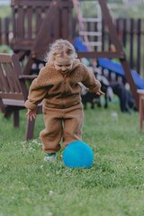 Beautiful 3-year-old girl playing on a neighborhood playground swinging, running on the grass, and enjoying fresh air. A joyful, natural moment full of real emotions and unaltered beauty