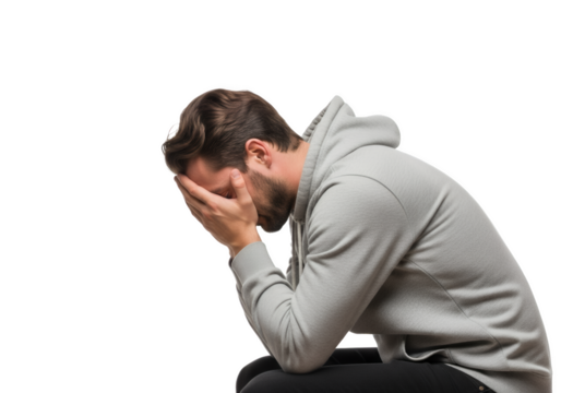 Depressed man covers face with hands in grief and emotional pain - Powered by Adobe