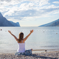 Woman meditating at the lake