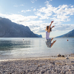 Woman jumping at the lake