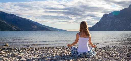 Woman meditating at the lake