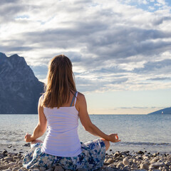 Woman meditating at the lake