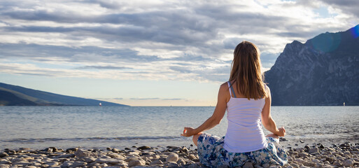 Woman meditating at the lake