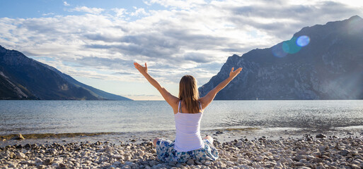 Woman meditating at the lake