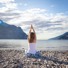 Woman meditating at the lake