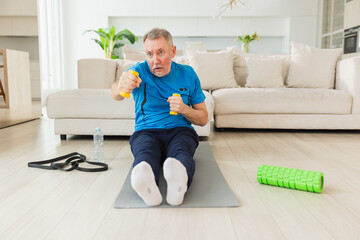 Fitness workout training. Senior man boxing punching picking up dumbbells. Old adult mature healthy...