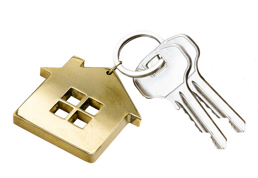 House keys with gold house shaped keychain isolated on white background