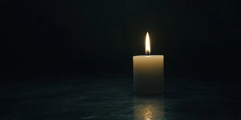 Fototapeta premium Glowing Candle in the Dark Reflecting Light