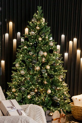 The interior of the bedroom is decorated for the Christmas holidays. Home interior with Christmas tree, armchair and gifts.