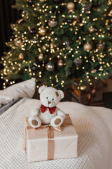 Designer Christmas tree decoration with lights. The concept of celebrating New Year and Christmas. Gifts in craft packaging under the Christmas tree.