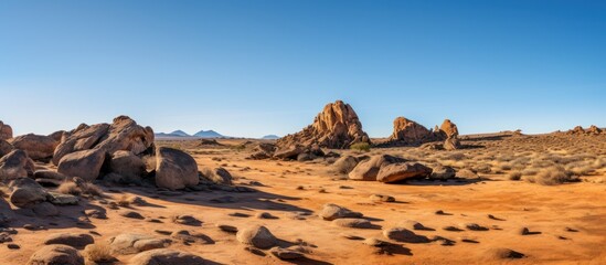 Monument Valley's iconic red sandstone rock formations dominate the arid desert landscape under a vast Arizona sky