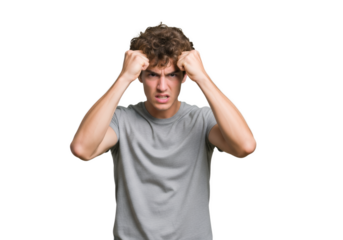 Frustrated young man shows aggression with a tense face and clenched fists.