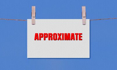 APPROXIMATE Symbol. Concept words APPROXIMATE on White Rectangle Paper Hanging on a Wooden...