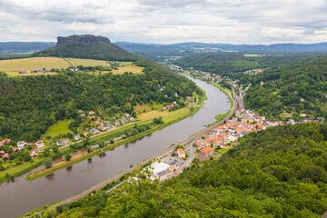Königstein, Germany – June 5, 2025: Scenic view from the historic fortress Königstein overlooking lush forests and distant hills in Saxon Switzerland under a dramatic cloudy sky
