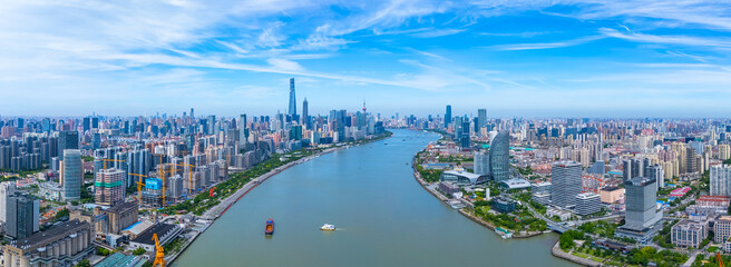 Aerial view of Shanghai skyscrapers in Pudong new area, with winding river.