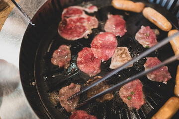 Grilling beef barbecue, enjoying delicious freshly cooked roast meat is a great way to relax on the weekend.