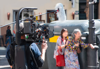 Film team shooting movie scene on outdoor location. Group filmmaking set production - Madrid, Spain