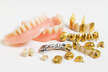 Various false teeth on white