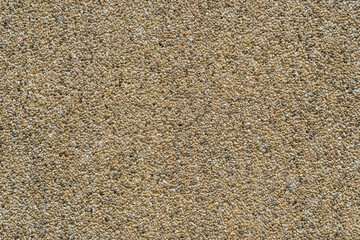 Close-Up Texture of Fine Sand Granules in Yellowish Tones for Background or Design Consistency