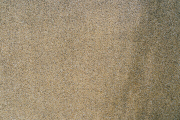 Close-Up of Fine Sand Textures on a Coastal Beach Surface Under Natural Lighting Conditions