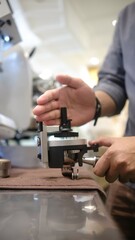 person barista using modern grinder machine to prepare coffee grounds in cafe features digital...