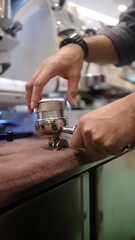 person barista using modern grinder machine to prepare coffee grounds in cafe features digital...