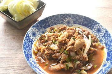 Thai spicy and sour chop duck meat salad and fresh cabbage on plate 