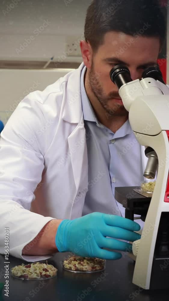 Poster animation of abstract shapes against caucasian male scientist using microscope at laboratory