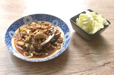 Thai spicy and sour chop duck meat salad and fresh cabbage on plate 