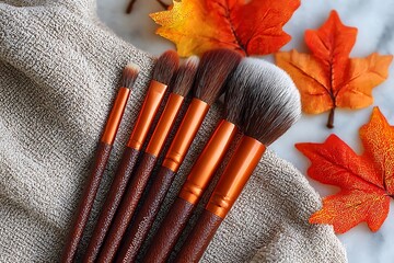Seasonal makeup brushes flatlay with orange foliage  
