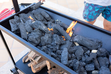 Preparing charcoal grill for outdoor barbecue cooking