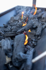 Burning charcoal embers glowing with intense heat in grill