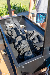 Preparing charcoal for outdoor barbecue grilling